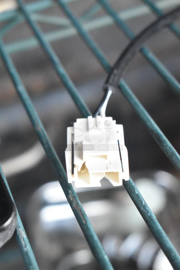 Brand new Avantco 17810032 fan motor, visible scratch and dent on white plastic component, connector shown.