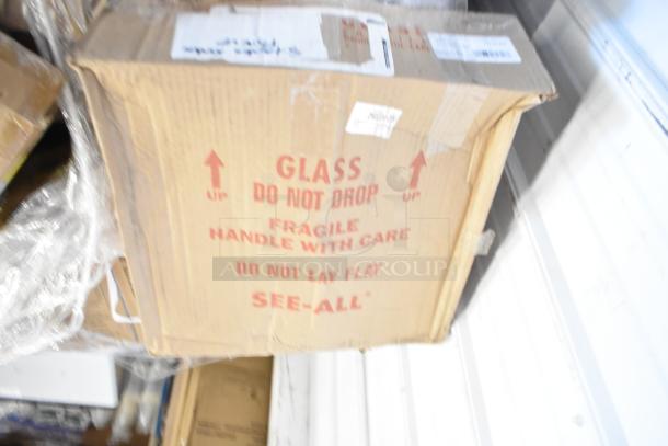 Cardboard box labeled "Fragile" and "Glass Do Not Drop," containing 45 new, scratch and dent items. Includes GoJo Handwash, Scott Dispenser, Zesta Crackers.