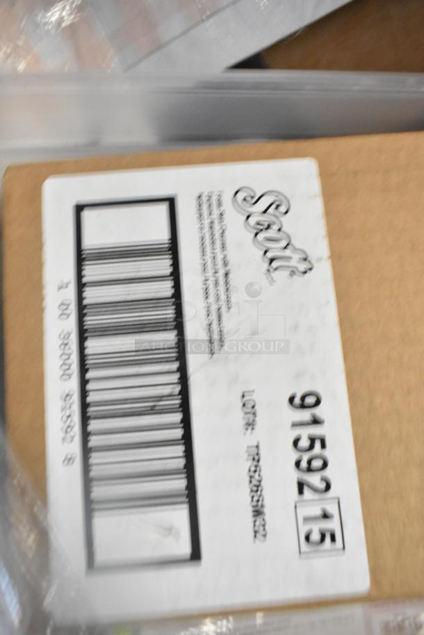 Box labeled "Scott 91592" containing scratch and dent items like GoJo Foam Handwash, Scott Dispenser, and Zesta Crackers.