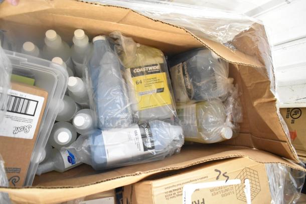 Box containing various new items like GoJo Foam Handwash, Scott 91592 dispenser, and Zesta Crackers, in original packaging.