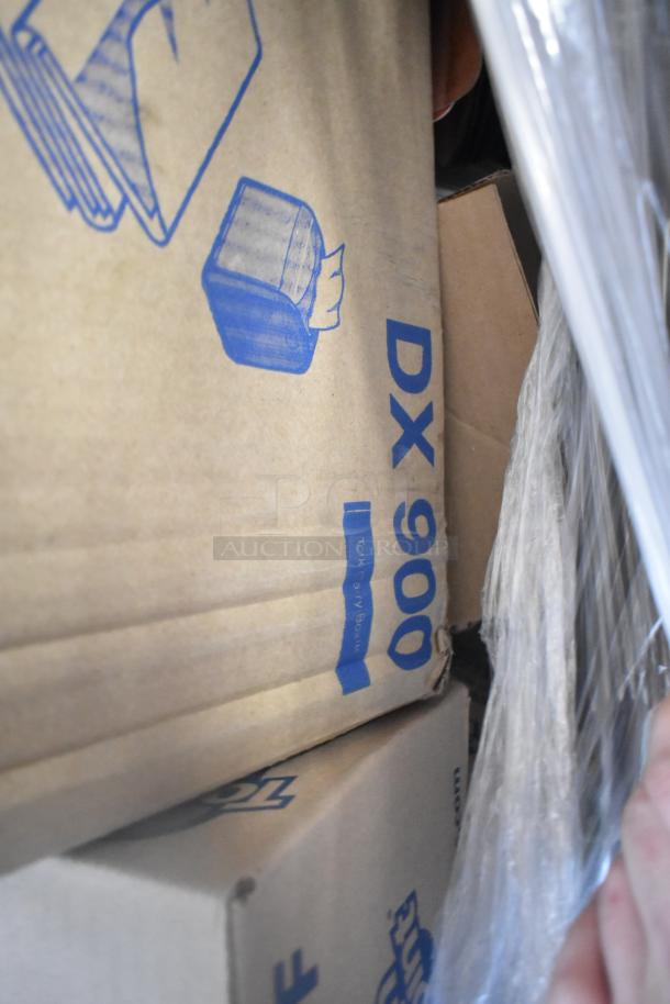 Boxes of scratch and dent items including various utility products. Visible marking: "DX 900." Multipack auction.