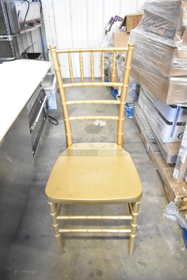 Gold dining chair with spindle back design, brand new condition, slight surface scratches visible.