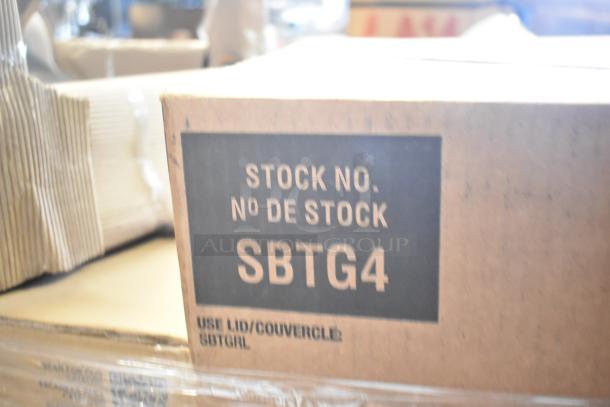 Box labeled "Stock No. SBTG4," part of 22 scratch and dent items including chair and touch panel, for auction.