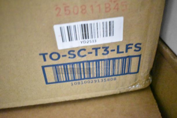 Cardboard box with markings "TO-SC-T3-LFS" and a barcode "10810029135808," indicating packaging for auction items.