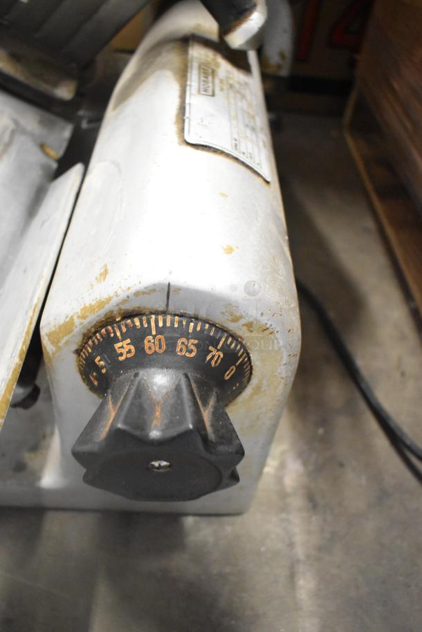 Hobart 1612 Commercial Meat Slicer, 115V, 1 Phase, shows wear, visible dial, sturdy build, used condition.