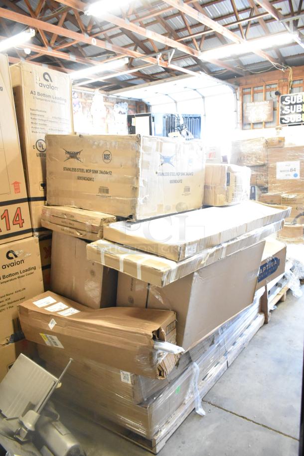 Boxes of 16 new scratch and dent items, including wall shelves and a work table, stacked in a warehouse.