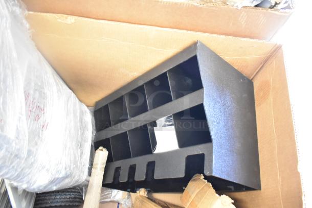 Scratch and dent Cooking Performance Group shelf unit in black, model 351GTCPG48NL, shown amidst packaging materials.