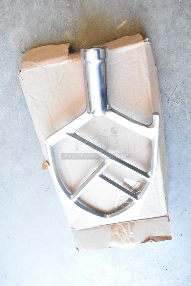 Avantco MX10H dough mixer paddle attachment, shiny metal, laid on a cardboard background, new condition.