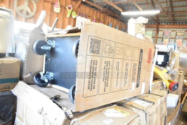 10 new "scratch and dent" items, including chafer and table. Some boxes damaged. Wheels visible; unpacking instructions printed.