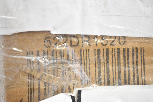 Close-up view of a barcode on cardboard packaging, partially covered with clear plastic wrap. Numbers "522DR1520" visible above the barcode.
