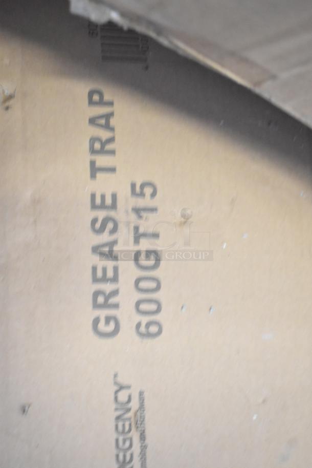 Cardboard box labeled "Regency Grease Trap, 600GT15." Part of a scratch and dent auction lot. Condition: new.