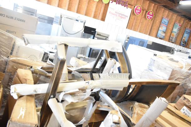 Eight brand new scratch and dent items, including chairs and outdoor table, wrapped and boxed in storage area.