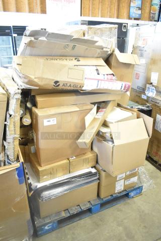 Stack of new scratch and dent items on pallets, including merchandise bags, folders, floor stand dispensers, and Dixie napkins, in original packaging.