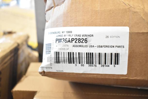 Cardboard box with label showing model PM36AP2826, assembled in the USA, containing mixed items like bags and napkins, in new scratch and dent condition.