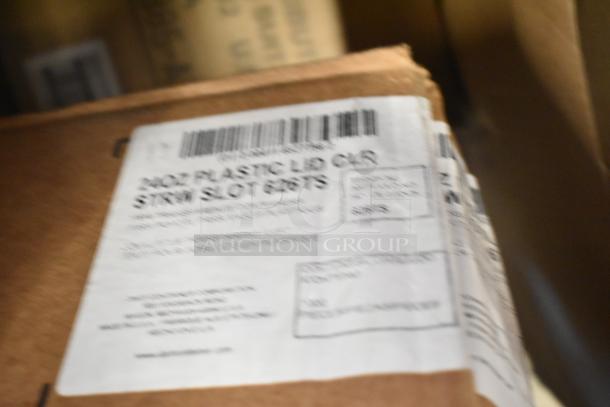 Label on a box showing "20oz Plastic Lid CLR, Straw Slot". Box contains scratch and dent items.