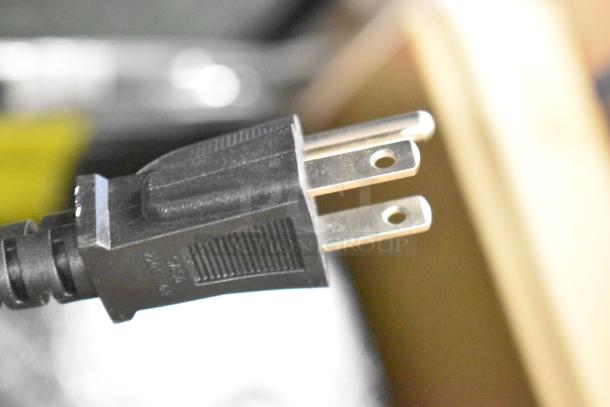 Close-up of a power plug for a Honeywell H115BCS 115 Can Cooler, showing a standard three-prong design.