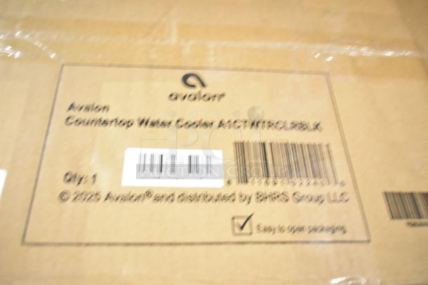 Cardboard box labeled "Avalon Countertop Water Cooler A1CTWTRCLBLK" with barcodes and distribution details.