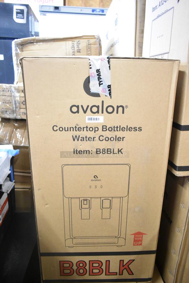 Avalon B8BLK countertop bottleless water cooler in box, showing branding and product description.