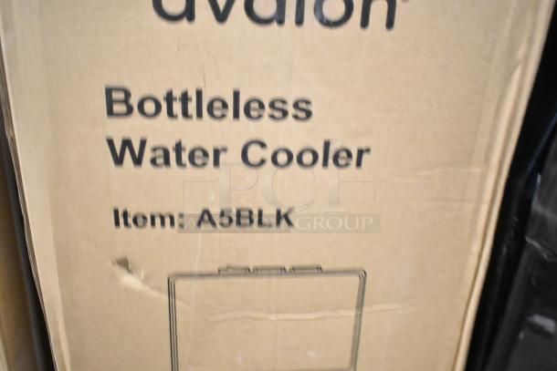 Alt text: Avalon A5BLK bottleless water cooler box with visible scratch and dent. New condition, self-cleaning feature.