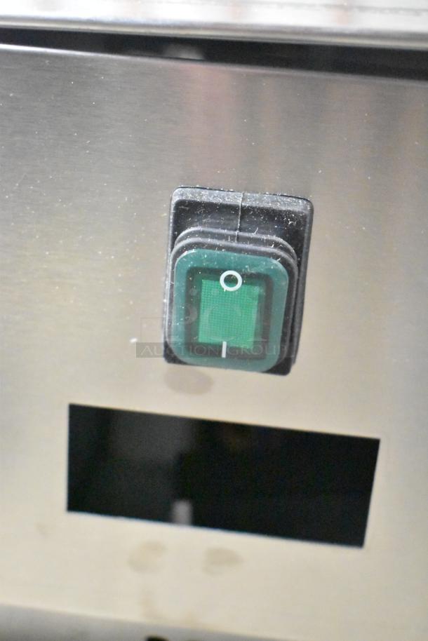 BRAND NEW Arctic Air ACP63 refrigerated prep station, 63", 115V, 1 phase. Minor scratch and dent. Close-up of on/off switch.