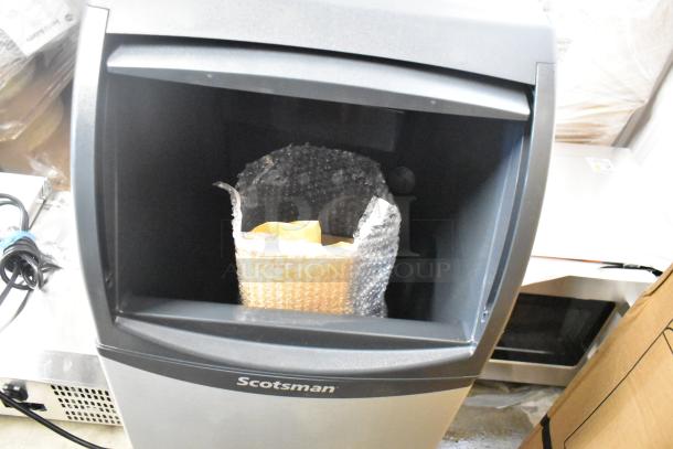 BRAND NEW Scotsman UN0815AX-1A undercounter nugget ice machine with 36 lb. bin, 115V, 1 Phase, visible packaging inside.