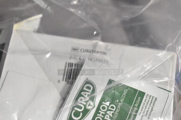 Auction lot with Diversey Crew Toilet Cleaner, Biotech Surface Cleaner, Curad Alcohol Pads. Items in plastic wrap.