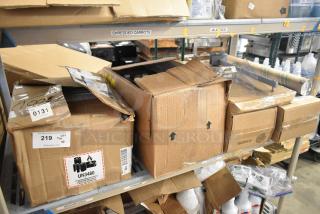 Tiered lot of various items including unopened Diversey Emulsion ProX. Boxes in warehouse, some labels showing UN3480 and quantity.