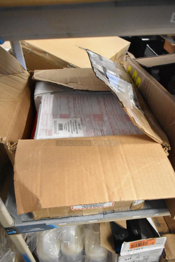 Cardboard boxes containing assorted items, including Diversey Emulsion ProX, with visible shipping labels and forms. Boxes show signs of wear.