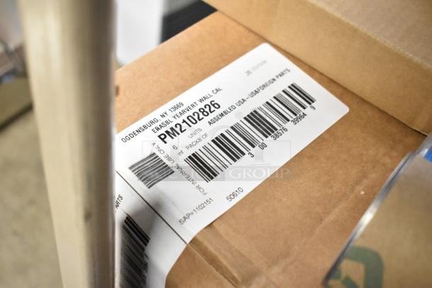 A cardboard box with a label showing "PM2102826", "6 units", and "assembled USA" text and barcodes.