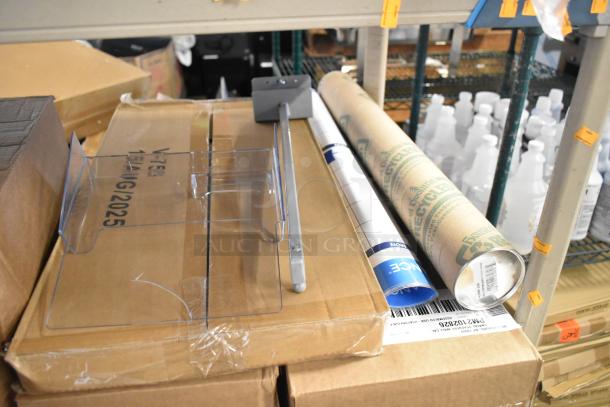 ALL ONE MONEY! tier lot with Diversey Emulsion ProX, layered on cardboard boxes, includes clear acrylic holder and rolled materials.