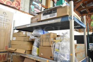 Two-tier shelf with desk calendars, Lysol cleaner, wire glove box holder, Purell soap, Coastwide hand soap, various boxes.