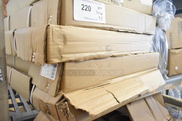 Two-tier lot with boxed items including desk calendars, Lysol cleaner, wire glove box holder, Purell soap, and Coastwide soap. Condition varies.