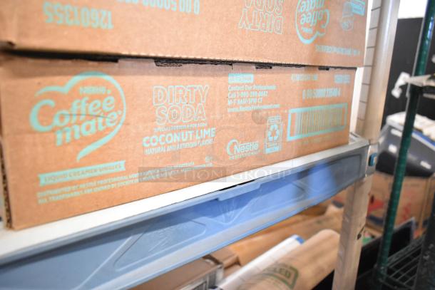 Two-tier lot containing various items: desk calendars, Lysol cleaner, wire glove box holder, Purell and Coastwide soaps.