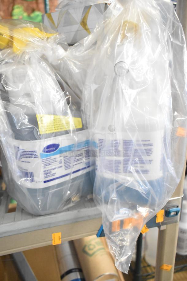 Two-tier lot with Diversey cleaning products, desk calendars, glove box holder, Purell soap, in protective packaging.