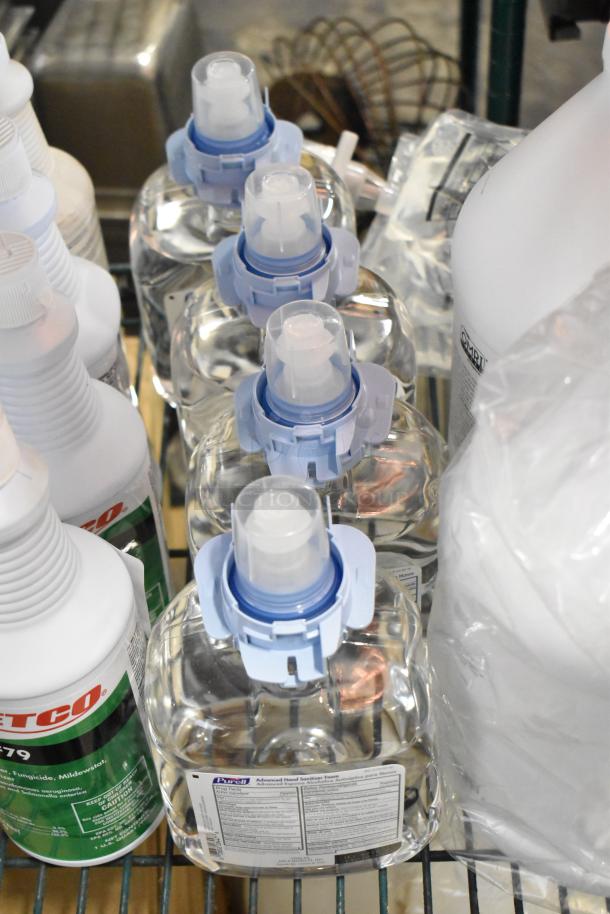 Two-tier lot with Betco AF79 Cleaner, Coastwide Disinfectant, Purell Hand Sanitizer, and Briotech Sanitizer bottles.