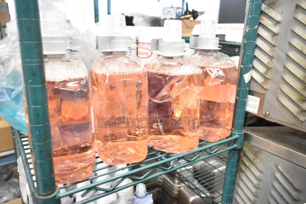 Two-tier shelf with assorted items, featuring clear bottles of Scott Foam Skin Cleanser, disinfectant spray, hand sanitizer.