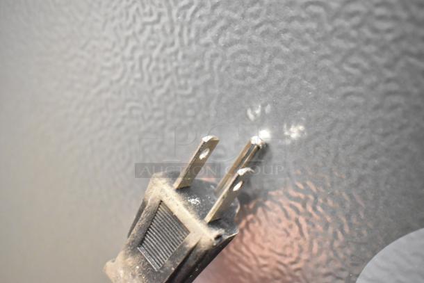 Dusty power plug of Honeywell H115BCS refrigerator against textured surface, highlighting scratch detail.