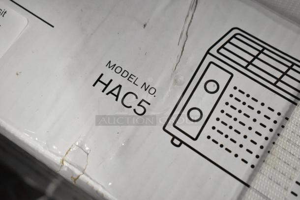 BRAND NEW SCRATCH AND DENT Honeywell HAC5 5,000 BTU air conditioner box showing model and design sketch.