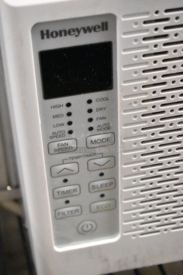 BRAND NEW Honeywell HAC6 6,000 BTU Window AC. Features controls for speed, mode, timer, and eco settings. Scratch and dent condition.