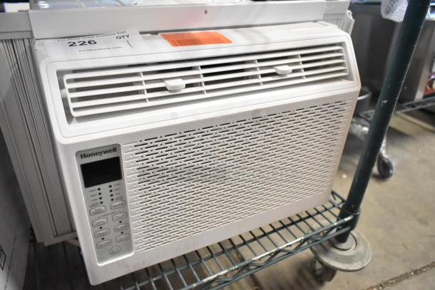 BRAND NEW Honeywell HAC6 6,000 BTU window air conditioner. 115V, scratch and dent condition, visible control panel, tags shown.