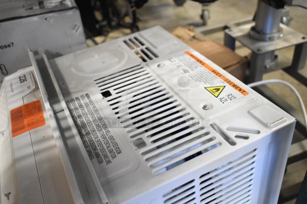 BRAND NEW Honeywell HAC6 6,000 BTU window air conditioner, 115V, minor scratches, safety warning label, model tag visible.