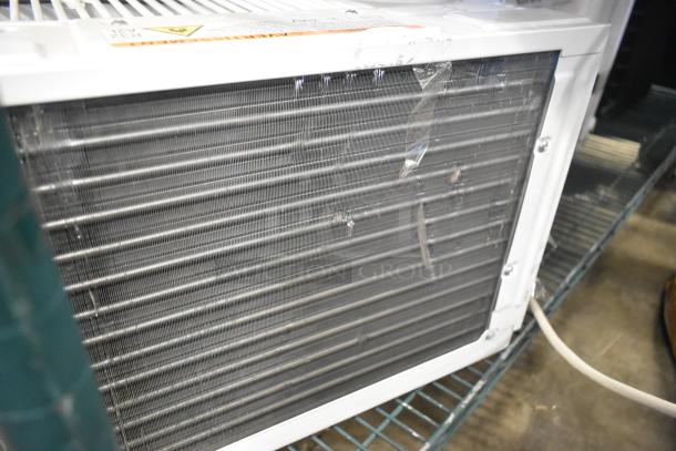 Brand new Honeywell HAC6 6,000 BTU window AC unit with minor scratches. 115 volts, 1 phase. Visible tape and slight dent.