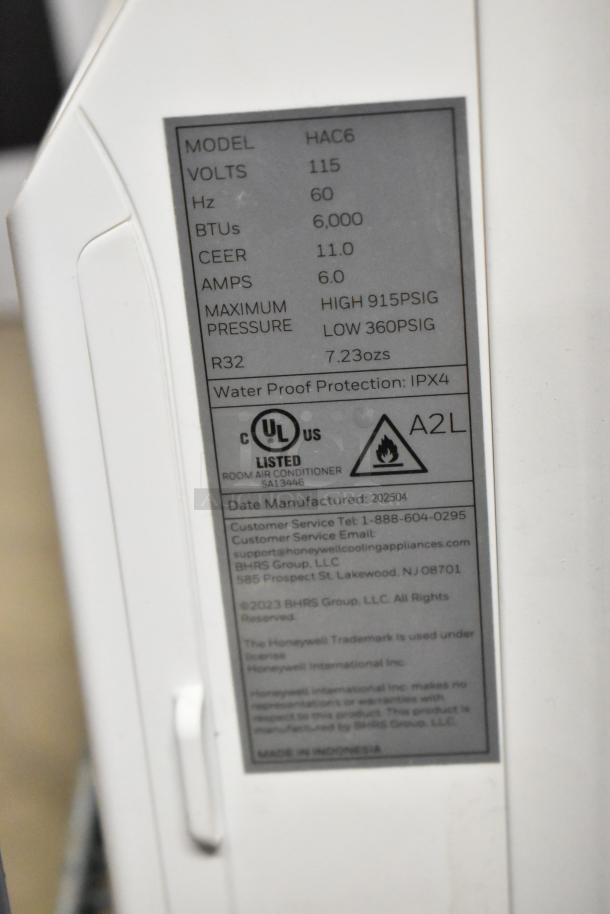 BRAND NEW SCRATCH AND DENT! Honeywell HAC6 6,000 BTU window AC, 115V, IPX4 waterproof. Tag shows model, volts, and UL certification.