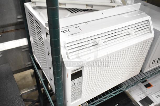 BRAND NEW Honeywell HAC6 6,000 BTU window air conditioner, 115V, scratch and dent, visible label “PCAuctions.com” lot 227.