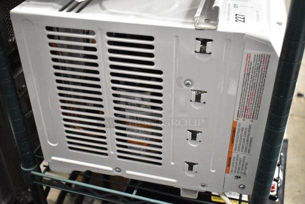 BRAND NEW Honeywell HAC6 6,000 BTU window-mounted AC unit, 115V, 1 phase. Visible dents on casing, includes warning labels.