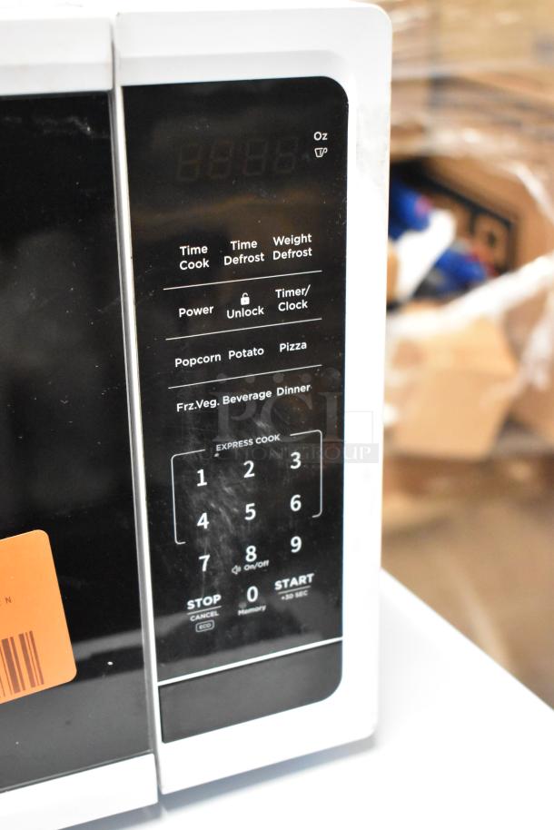 Brand new Vissani EM720C2KHWCL 0.7 cu. ft. countertop microwave, 700W, visible control panel with functions, minor scratches.