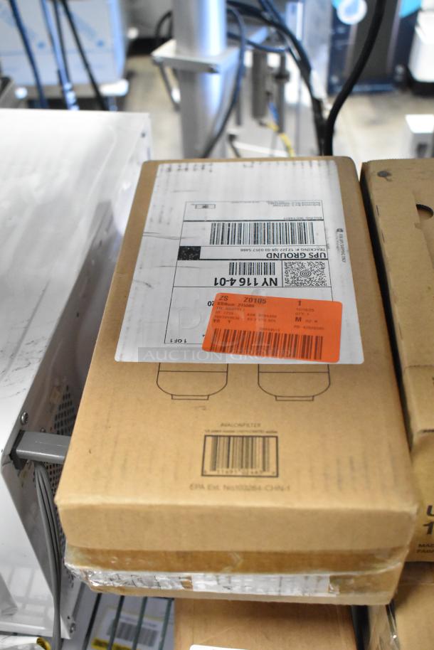 Box of brand new scratch and dent items including Avalon filter, cup dispenser, Sony UPP-110HG roll, bottles.