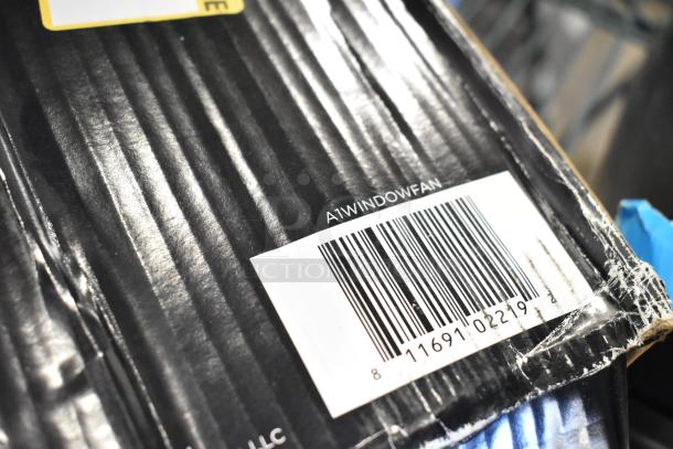 Box close-up showing barcode and "A1WINDOWFAN" marking, indicating the Genesis Twin Fan High Velocity Reversible AirFlow Fan.