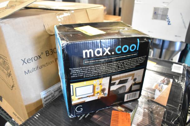 Boxes containing a Genesis Twin Fan and Genesis 6-Inch Clip Fan. New, labeled "max.cool" and "Xerox B305."