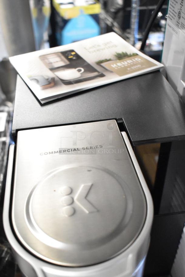 Keurig K-2550 Single Cup Coffee Machine, 115V, Commercial Series, sleek metallic finish, includes manual.